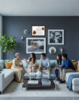 Family sitting on a couch in a modern living room with decor elements and the Bloodhound-Heritage History Dog Breed Portrait on wall