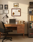 Home office with desk, chair, books, and a Bloodhound-Heritage History Dog Breed Portrait on a wall.