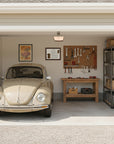 Dachshund-Heritage History Dog Breed Portrait behind a Beige Volkswagen Beetle in a garage with tools and equipment on the wall and shelves.