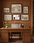 Dachshund-Heritage History Dog Breed Portrait behind a Wooden desk with laptop, mug, and plant in a room with wooden walls and bookshelf.