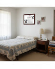 Bedroom with bed, nightstand, chair, and Dalmatian-Heritage History Dog Breed Portrait on the wall.
