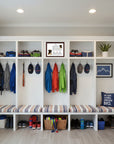 Boxer-Heritage History Dog Breed Portrait in a Mudroom with white storage shelves featuring jackets, shoes, and decorative items.